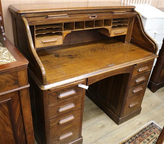 A 1920s oak tambour desk W.122cm